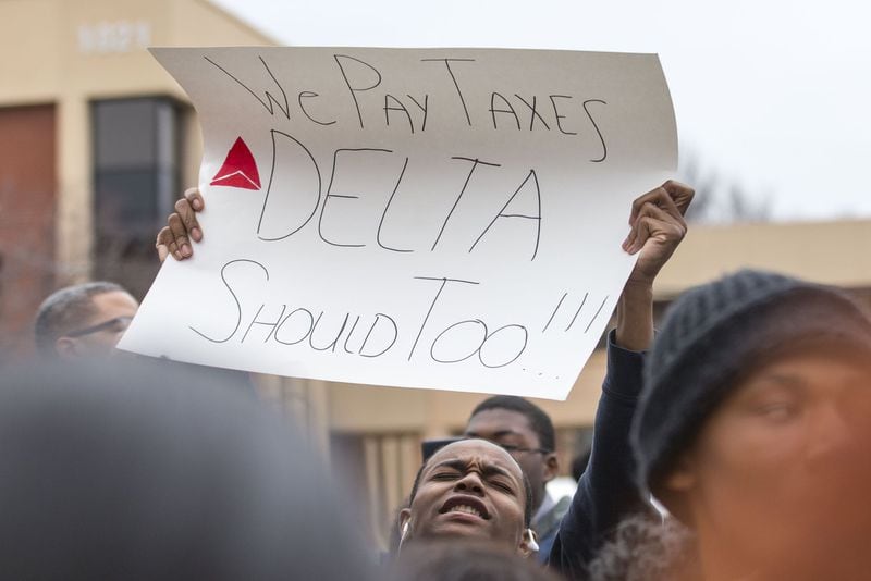 A Clayton County Public Schools student holds up a sign at the entrance of Delta Air Lines’ headquarters on Feb. 13, 2018, to protest Georgia House Bill 821. The proposal would restore a $50 million tax break on jet fuel purchases — saving Delta about $40 million annually. But the Clayton County school system counts on that money. (ALYSSA POINTER/alyssa.pointer@ajc.com)