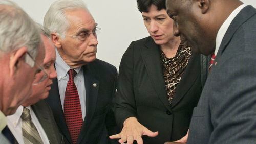 Tom Worthan, third from left (red tie), consults with other county commission chairs from around metro Atlanta in 2011. Worthan is a three-term chairman. (AJC file / Bob Andres)