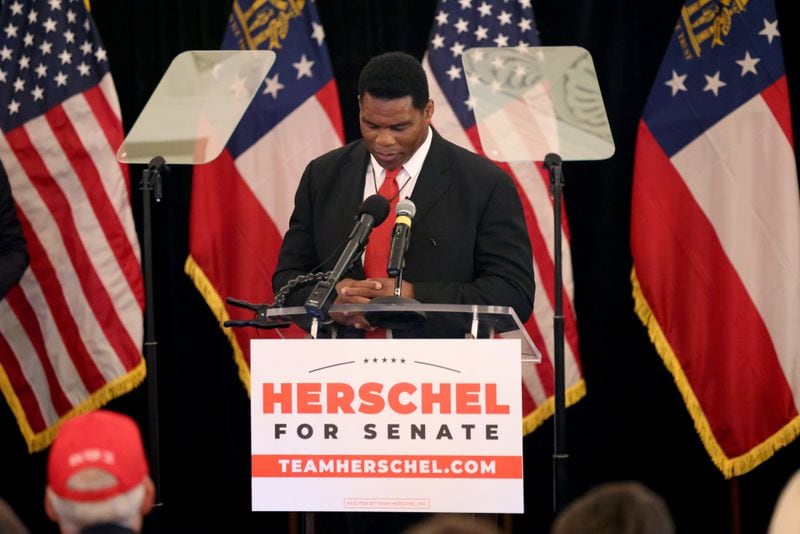 U.S. Senate candidate Herschel Walker holds a moment of silence for the victims of a school shooting in Texas before speaking after his Republican primary win on Tuesday. (Jason Getz / Jason.Getz@ajc.com)