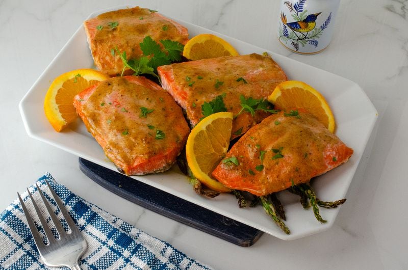 You don't have to worry about thawing frozen salmon fillets before making Baked Orange Mustard Salmon with Asparagus. (Virginia Willis for The Atlanta Journal-Constitution)