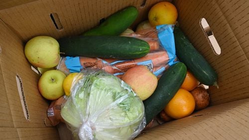 Officials and volunteers handed out fresh food to residents at a recent food distribution event in DeKalb County.