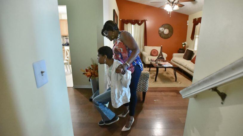 Norma Stanley helps her daughter, Sierra, as she walks to their kitchen in Decatur. Mother’s Day has always been a bit of a sensitive time for Norma Stanley. Her daughter, Sierra, who is now 30 and has a developmental disability, has no idea what Mother’s Day is. HYOSUB SHIN / HSHIN@AJC.COM