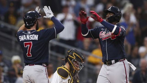 Braves' Jorge Soler, right, is congratulated by Dansby Swanson (7) after hitting a three-run home run against the San Diego Padres in the sixth inning of a baseball game Saturday, Sept. 25, 2021, in San Diego. (AP Photo/Derrick Tuskan)