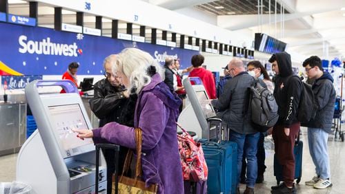 Travelers flying with Southwest print tags for their checked bags on Wednesday, December 28, 2022, at Hartsfield-Jackson International Airport in Atlanta.  Southwest airlines canceled over 2,000 flights. CHRISTINA MATACOTTA FOR THE ATLANTA JOURNAL-CONSTITUTION.