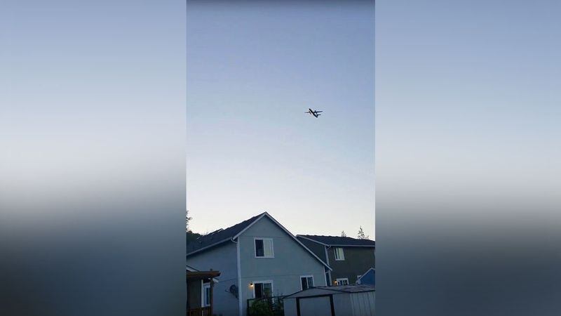 This photo taken from video provided by Courtney Junka shows the stolen Horizon Air turboprop plane flying over Eatonville, Wash., Friday, Aug. 10, 2018. Officials say an airline employee stole the plane with no passengers aboard, and took off from Sea-Tac International Airport Friday night before crashing into an island.