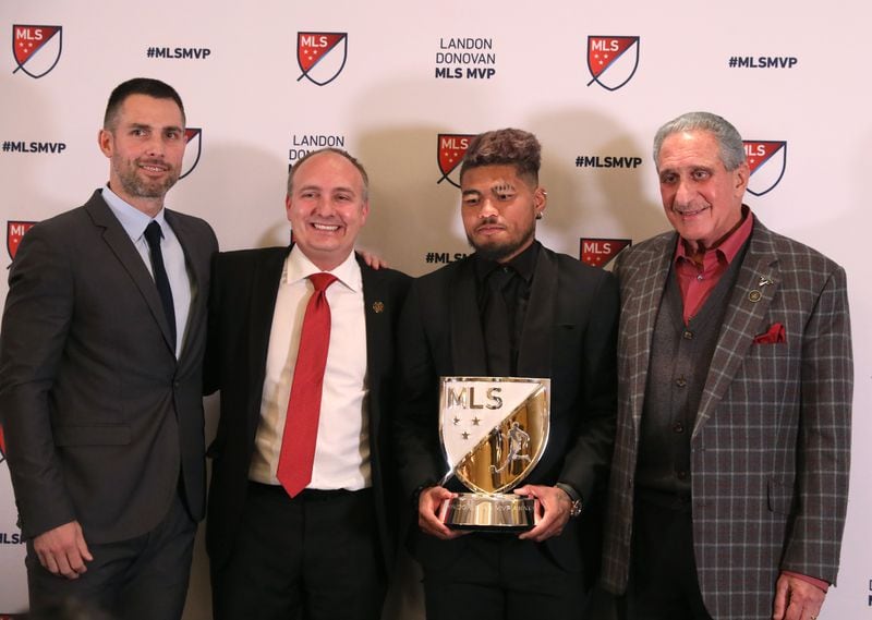  Atlanta United forward Josef Martinez, center, poses with Carlos Bocanegra,  United technical director, Darren Eales, United president, and Arthur Blank,  United owner, after Martinez was awarded the MLS MVP on December 5, 2018, in Atlanta.  (JASON GETZ/SPECIAL TO THE AJC)
