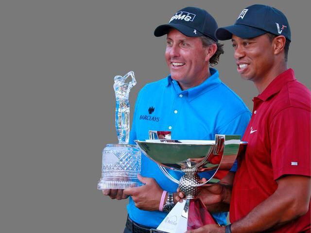 Phil Mickelson holds The Tour Championship trophy and Tiger Woods with the FedEx Cup trophy after The Tour Championship golf tournament at East Lake Golf Club, Atlanta, Georgia in September of 2009.