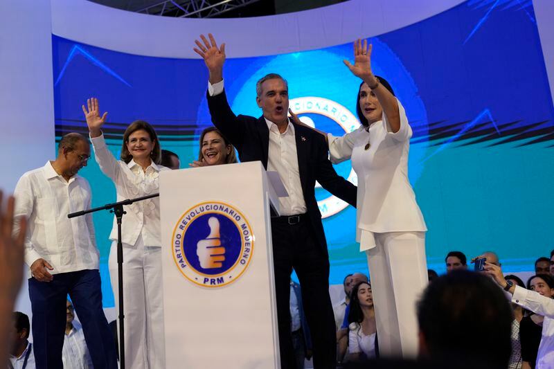 Incumbent presidential candidate Luis Abinader, second from right, addresses supporters after the first vote count showed him leading in general elections in Santo Domingo, Dominican Republic, Sunday, May 19, 2024. (AP Photo/Matias Delacroix)