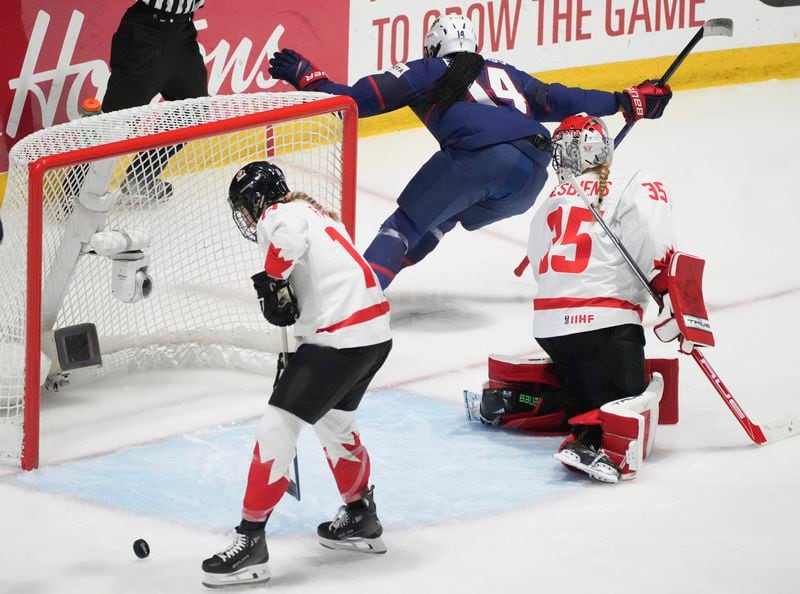 United States' Laila Edwards (14) scores on Canada goaltender Ann-Renee Desbiens (35) during the first period in the final at the IIHF Women's World Hockey Championships in Utica, N.Y., Sunday, April 14, 2024. (Christinne Muschi/The Canadian Press via AP)