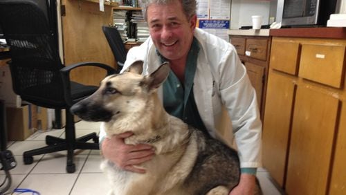 Dr. Michael Good hangs out with one of his rescue dogs, a German shepherd named Phillip. Good, owner of Town & Country Veterinary Clinic in Marietta, is founder of the nonprofit Homeless Pets Foundation and Homeless Pet Clubs of America. GRACIE BONDS STAPLES / GSTAPLES@AJC.COM