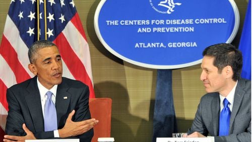President Barack Obama speaks as Dr. Tom Frieden (right), Director of CDC, listens at the Centers for Disease Control and Prevention in Atlanta on Tuesday, September, 16, 2014.