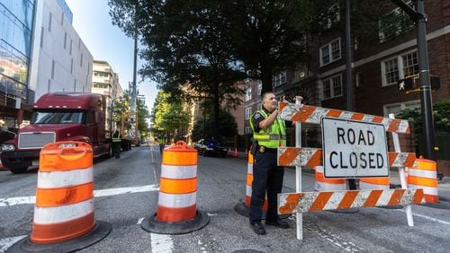 Molena, Georgia assistant police chief, Jesus Lopez helped putting up closure signage on 6th Street on Peachtree Street. A construction project that got underway on Wednesday in Midtown Atlanta closed a portion of Peachtree Street for several days, officials said.