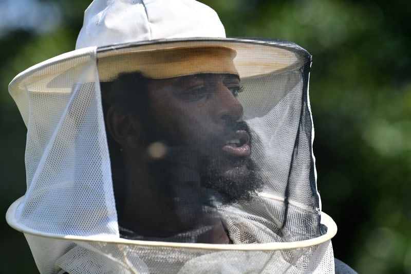 William Crumpler II, known as “Bill the Bee Man”, speaks to participants during an educational event to learn harvesting honey and beekeeping at Metro Atlanta Urban Farm, Thursday, July 6, 2023, in College Park. (Hyosub Shin / Hyosub.Shin@ajc.com)