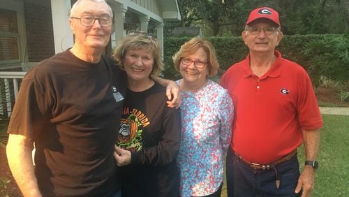 John Branyan (R) and his wife Mary have attended the Georgia-Florida game in Jacksonville for 41 years in a row, not including 1994 and '95 when the game was played on the school's respective campus. Most of those trips were made with their friends Dale and Marilyn Lamb of Moreland (left), who posed with them Wednesday at the rental house on St. Simons Island they will share this week. (Photo provided)