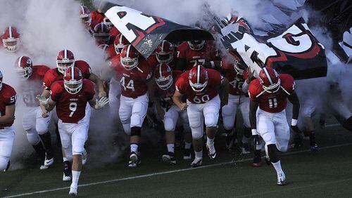 Aug. 24, 2012, COLLEGE PARK, GA: The Woodward Academy War Eagles take the field against Lovett for the first half of their high school football game at Woodward Academy's Colquitt Stadium in College Park, Ga., on Friday, Aug. 24, 2012. DAVID TULIS/AJC SPECIAL