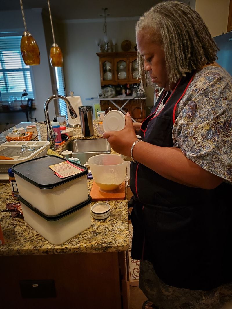 SEPTEMBER 19, 2020 — Janice Cockfield makes peanut butter cookies at her South Fulton home as a treat for her twin, Janese Cockfield. In her pre-coronavirus life, Janice often baked cookies for her Delta Air Lines co-workers. "This was the first time she'd baked since before she was hospitalized" for COVID-19, said Janese. "It wore her out, but she did it." (Credit: Janese Cockfield / Contributed)