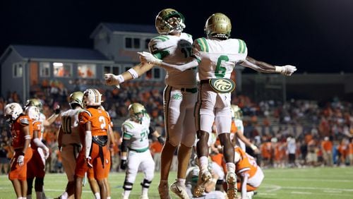 August 20, 2021 - Kennesaw, Ga: Buford running back Victor Venn (6) celebrates his rushing touchdown with Callum Fraser (15) during the second half against North Cobb at North Cobb high school Friday, August 20, 2021 in Kennesaw, Ga.. Buford won 35-27. JASON GETZ FOR THE ATLANTA JOURNAL-CONSTITUTION



