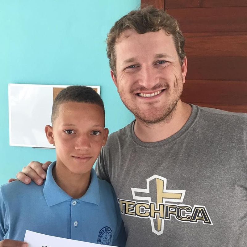 Georgia Tech fan Chris Tanton (right), who lives in Boca Chica, Dominican Republic, as a director of a ministry for young men facing poverty and a lack of family support. (Courtesy Chris Tanton)