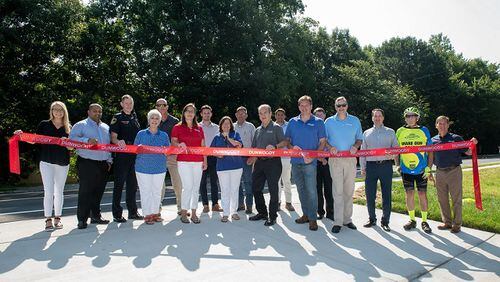 The city of Dunwoody recently held a ribbon-cutting ceremony to commemorate the completion of a sidewalk project on Tilly Mill Road that includes new sidewalks and bike lanes. CONTRIBUTED