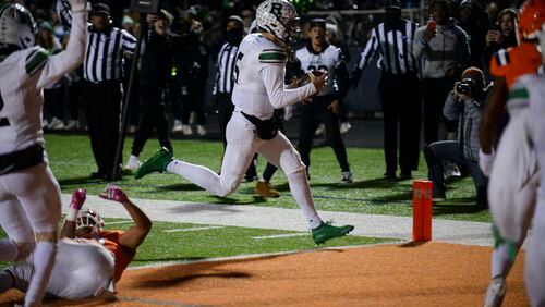 Roswell quarterback Robbie Roper (5) carries the ball into the endzone to score the Hornet’s game winning touchdown in the final minutes of the game Friday, Nov. 19, 2021 at North Cobb High School. (Daniel Varnado/ For the Atlanta Journal-Constitution)