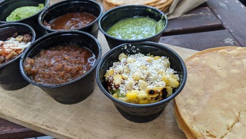 Alma Cocina's guacamole and salsa tasting features three guacamoles and three salsas, with a stack of housemade corn tostadas. Courtesy of Paula Pontes