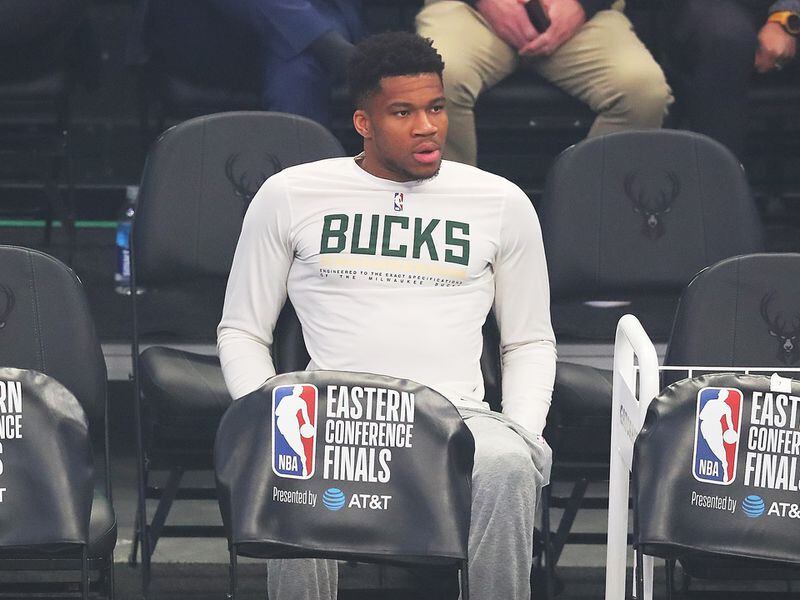 Injured Milwaukee Bucks forward Giannis Antetokounmpo watches from the bench as his team takes on the Atlanta Hawks in game 5 of the NBA Eastern Conference finals Thursday, July 1, 2021, in Milwaukee.   “Curtis Compton / Curtis.Compton@ajc.com”
