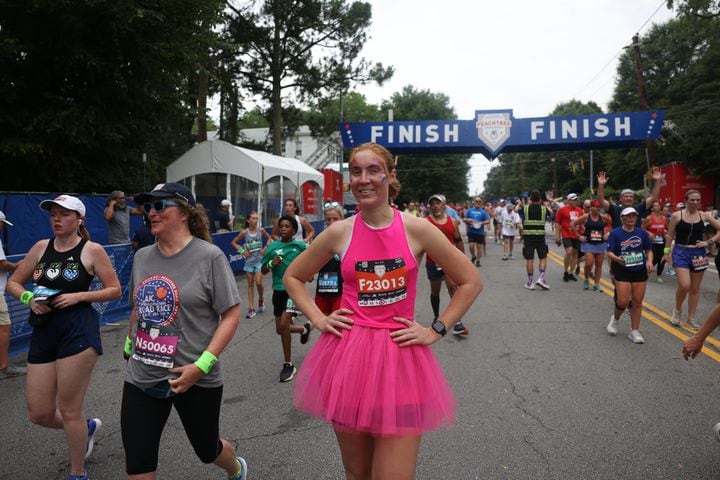Costumed runner at the finish of the 54th running of The Atlanta Journal-Constitution Peachtree Road Race on Tuesday, July 4, 2023.   (Jason Getz / Jason.Getz@ajc.com)
