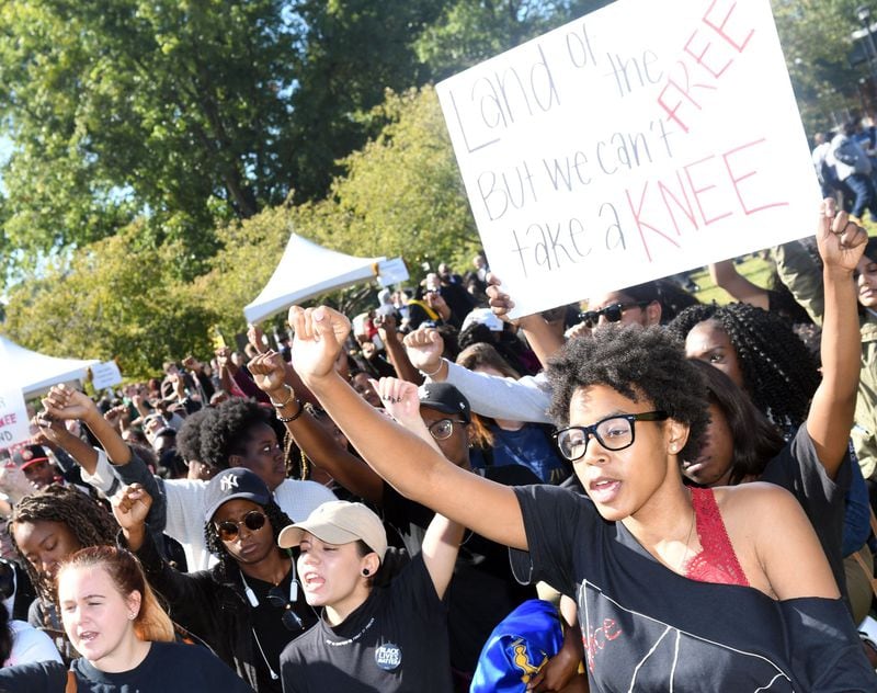 Diamond Porterfield, a freshman, majoring in early childhood education, (right) protests at KSU on October 19, 2017. A group of Kennesaw State University students are protesting in support of the KSU cheerleaders who want to take a knee in protest of police brutality during the national anthem . 