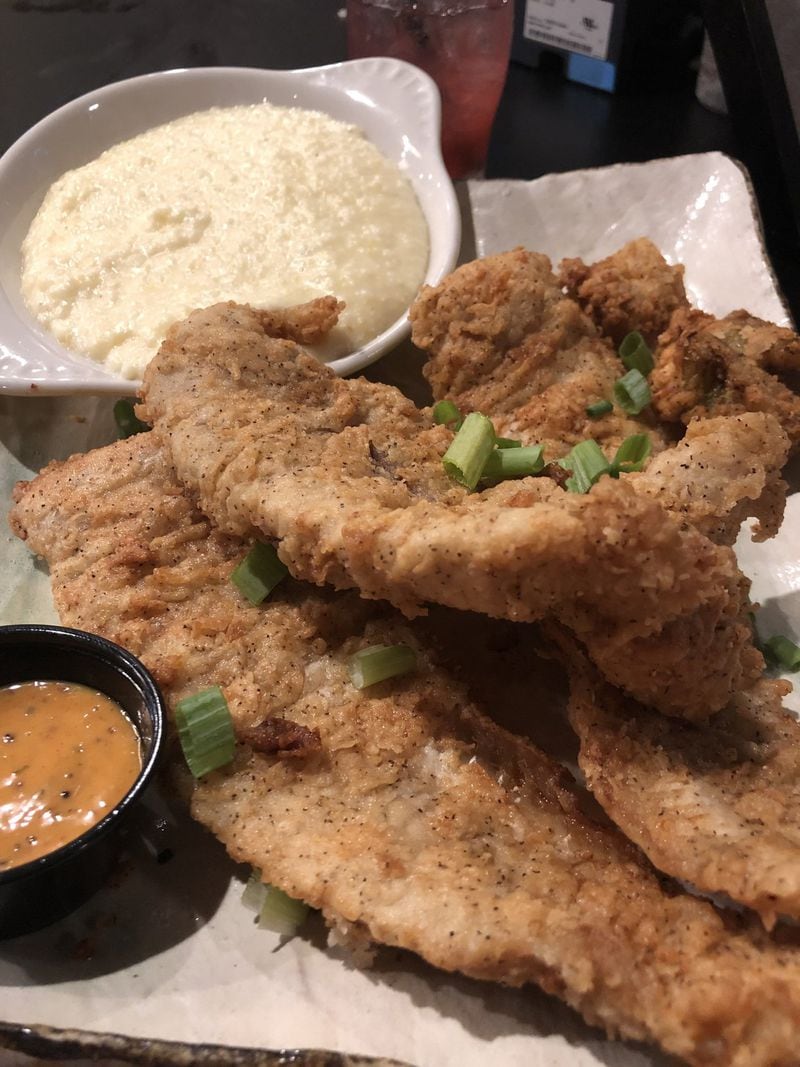 Southern fried fish and grits are among the solid options on the brunch-all-day menu at the Real Milk & Honey in College Park. CONTRIBUTED BY WENDELL BROCK