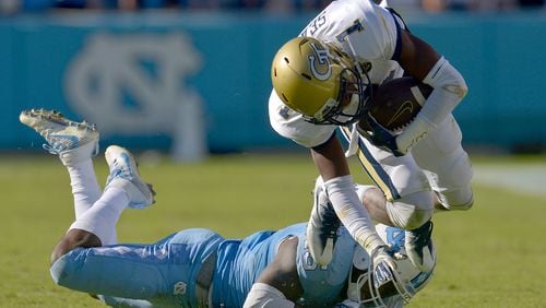 Donnie Miles #15 of the North Carolina Tar Heels trips up Qua Searcy #1 of the Georgia Tech Yellow Jackets during the game at Kenan Stadium on November 5, 2016 in Chapel Hill, North Carolina. North Carolina won 48-20. (Photo by Grant Halverson/Getty Images)
