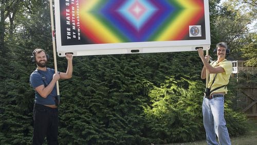 Visual artist Matthew Terrell (left) and fabricator George Faughnan (right) show off their latest project, The Hate Shield, at a residence in Atlanta, Wednesday, October 9, 2019. The walls are designed to be wielded up through harnesses and poles to block tall hateful signs. (Alyssa Pointer/alyssa.pointer@ajc.com)