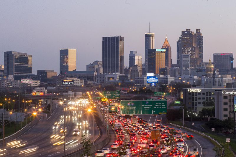 Early morning commuters began to pack the northbound Downtown Connector as the sun rose over Atlanta on Wednesday. ALYSSA POINTER / ALYSSA.POINTER@AJC.COM