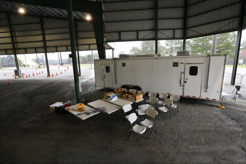 March 17, 2020 Marietta: Health department officials are setting up for the drive-thru testing of coronavirus in Jim Miller Park with a medical trailer seen at the Cobb County Outdoor Arena inside the park on Tuesday, March 17, 2020, in Marietta. Curtis Compton ccompton@ajc.com