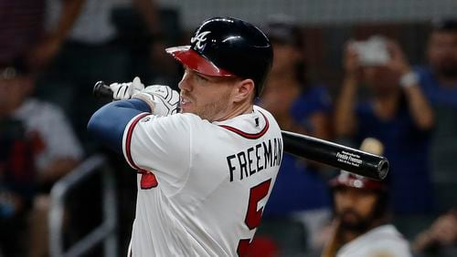 Braves’ Freddie Freeman follows through on his game-winning hit in the eighth inning. (AP Photo/John Bazemore)
