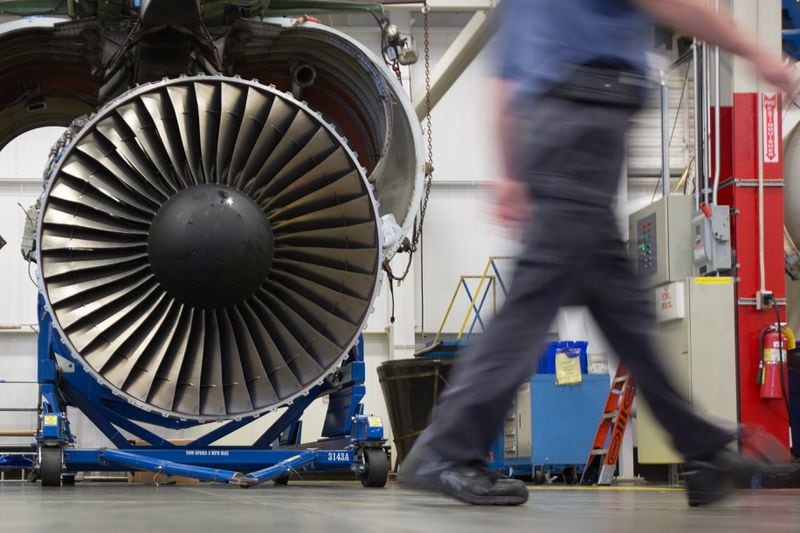 A Delta TechOps employee walks past an airplane engine inside a Delta TechOps building near Hartsfield-Jackson Atlanta International Airport, Monday, Oct. 26, 2015, in Atlanta. Delta announced a new partnership with Rolls Royce as an approved maintenance center. BRANDEN CAMP/SPECIAL