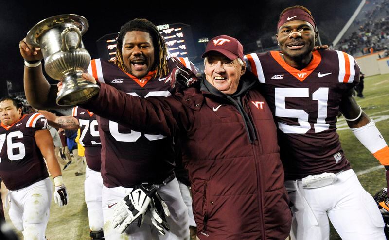 BLACKSBURG, VA - NOVEMBER 28: Head coach Frank Beamer celebrates with defensive end Melvin Keihn #51 and offensive lineman Laurence Gibson #63 of the Virginia Tech Hokies after their victory over the Virginia Cavaliers at Lane Stadium on November 28, 2014 in Blacksburg, Virginia. Virginia Tech defeated Virginia 24-20. (Photo by Michael Shroyer/Getty Images)