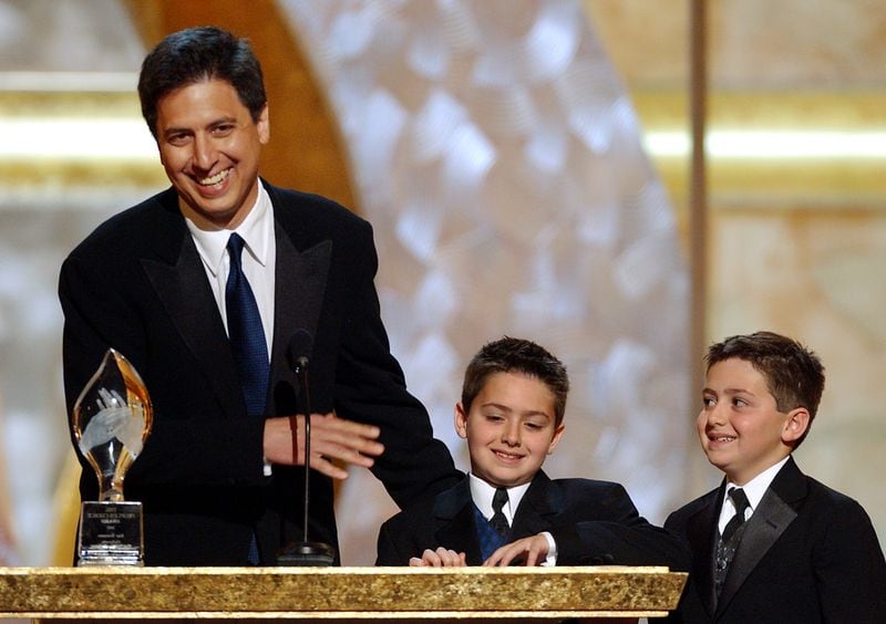 In this 2002 photo, "Everybody Loves Raymond" star Ray Romaon accepts a People's Choice Award with the help of his real-life twin sons, Gregory and  Matthew. (AP Photo/Kim D. Johnson)