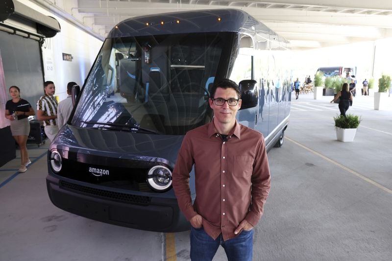 R.J. Scaringe, the founder and chief executive of Rivian, with one of Amazon’s new Rivian electric powered delivery vans in Chicago. EV startup Rivian has paused negotiations with Mercedes on a possible van partnership to conserve cash for its operations in Illinois and Georgia, the Wall Street Journal reports today. (Terrence Antonio James/Chicago Tribune/TNS)
