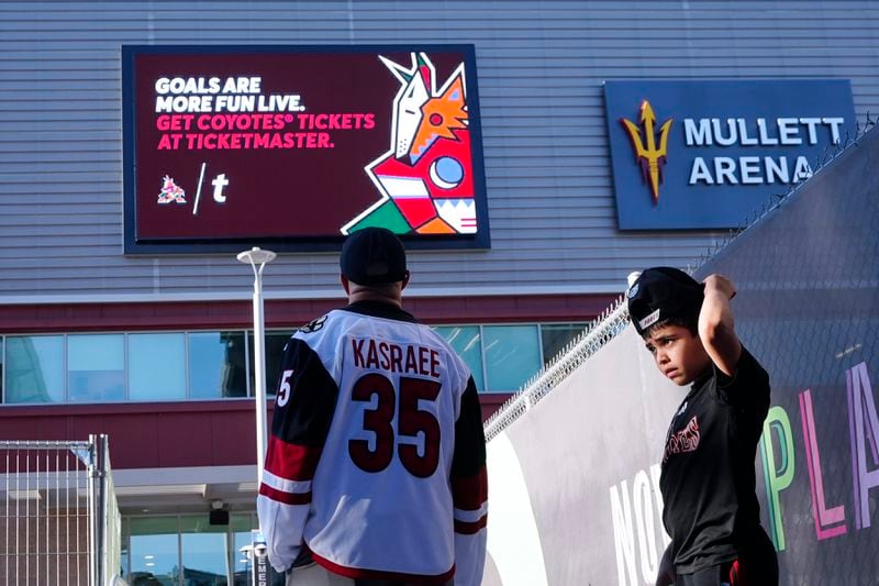 Arizona Coyotes fans start to gather for the franchise's final NHL hockey game in the Phoenix area, against the Edmonton Oilers, at the main entrance to Mullett Arena on Wednesday, April 17, 2024, in Tempe, Ariz. (AP Photo/Ross D. Franklin)