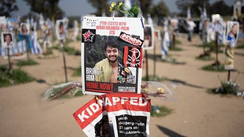 FILE - A poster depicting Israeli-American hostage Hersh Goldberg-Polin is displayed in Re'im, southern Israel at the Gaza border, Feb. 26, 2024, at a memorial site for the Nova music festival site where he was kidnapped to Gaza by Hamas on Oct. 7, 2023. Hamas on Wednesday, April 24, 2023, released a recorded video of an Israeli American still being held by the group. The video was the first sign of life of Hersh Goldberg-Polin since Hamas’ Oct. 7 attack on southern Israel. It was not clear when the video was taken. (AP Photo/Maya Alleruzzo, File)