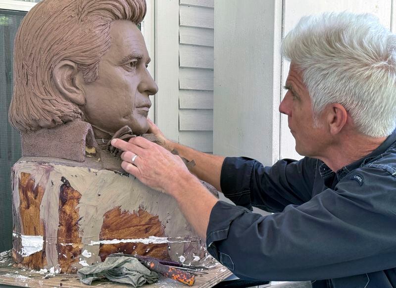 Artist Kevin Kresse, works on a clay bust of Johnny Cash, April 23, 2024 in Little Rock, Ark. Kresse's full sculpture of Cash will be unveiled at the U.S. Capitol as part of the Statuary Hall collection, later this year. (AP Photo/Mike Pesoli)