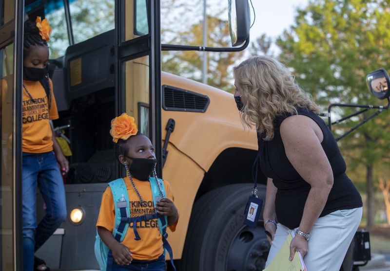 Atkinson Elementary School Kindergartner Brooklyn Mitchell is greeted by assistant principal Monica Keel on the first day at West Georgia Technical College’s Coweta Campus in Newnan. (Alyssa Pointer / Alyssa.Pointer@ajc.com)
