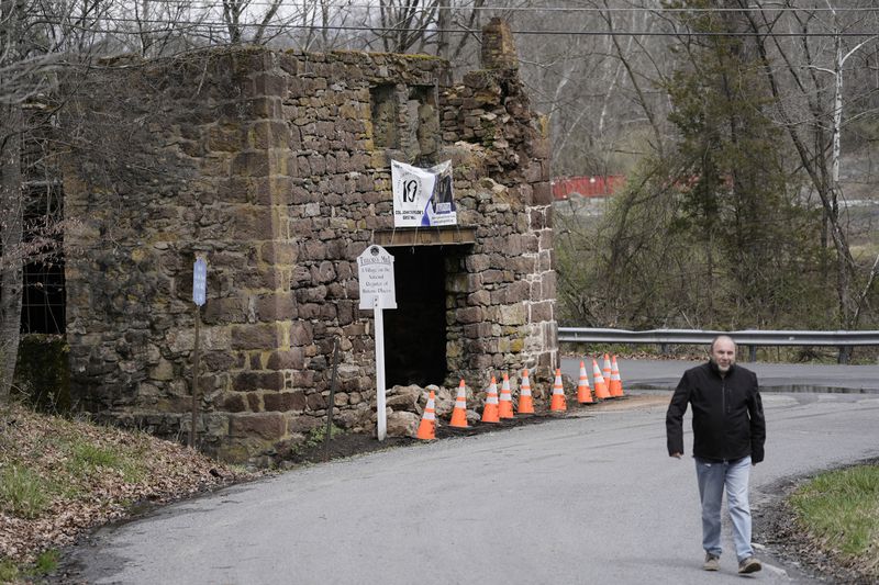 Cones cordon off fallen debris from the historic Taylor's Mill in Lebanon, N.J., Friday, April 5, 2024. The U.S. Geological Survey reported a quake at 10:23 a.m. with a preliminary magnitude of 4.8, centered near Whitehouse Station, New Jersey, or about 45 miles west of New York City and 50 miles north of Philadelphia. (AP Photo/Matt Rourke)