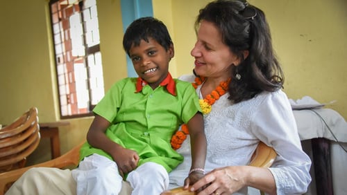 Caroline Boudreaux, pictured here with an orphan, founded the Miracle Foundation to help ensure children like him reach their full potential. The nonprofit recently launched its annual Mother s Day campaign to provide for motherless children in places like India, Uganda, Sierra Leone, Kenya and Ethiopia. CONTRIBUTED