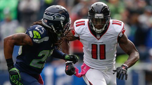 Wide receiver Julio Jones runs a pass route against cornerback Richard Sherman during their matchup Oct. 16, 2016, in Seattle.