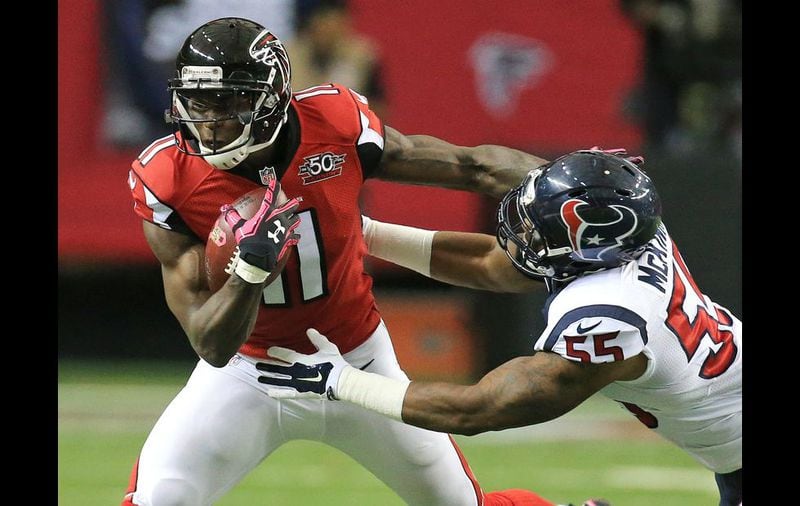 Falcons wide receiver Julio Jones makes a reception against Texans linebacker Benardick McKinney during the first half in a football game on Sunday, Oct. 4, 2015, in Atlanta. The Falcons beat the Texans 48-21 to improve their record to 4-0. Curtis Compton