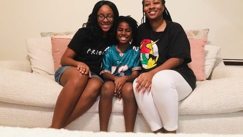 DaVina Jackson (right) of Fort Valley, Georgia, and her children, daughter JeNaii (left) and son JeKaii (center) returned from China last week. They are seen here at her mother’s house, where they are waiting out the two-week quarantine period. CONTRIBUTED: DAVINA JACKSON
