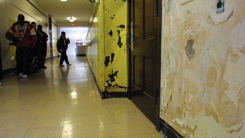 10/29/02 -- 1031arch-p -- Crumbling plaster walls and beat-up lockers are among the signs of deterioration at Kiser Middle School.