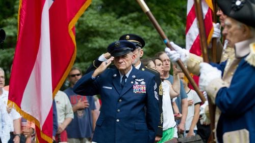 Tom Jones stands at attention and salutes during the presentation of the colors at the Memorial Day Ceremony in Roswell on Monday, May 28, 2018.  STEVE SCHAEFER / SPECIAL TO THE AJC