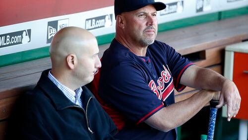 Braves general manager John Coppolella (left) and manager Fredi Gonzalez sit in the dugout at Nationals Park in Washington D.C. before speaking with the media after outfielder Hector Olivera was arrested when a woman accused him of assault and battery. (AP photo)